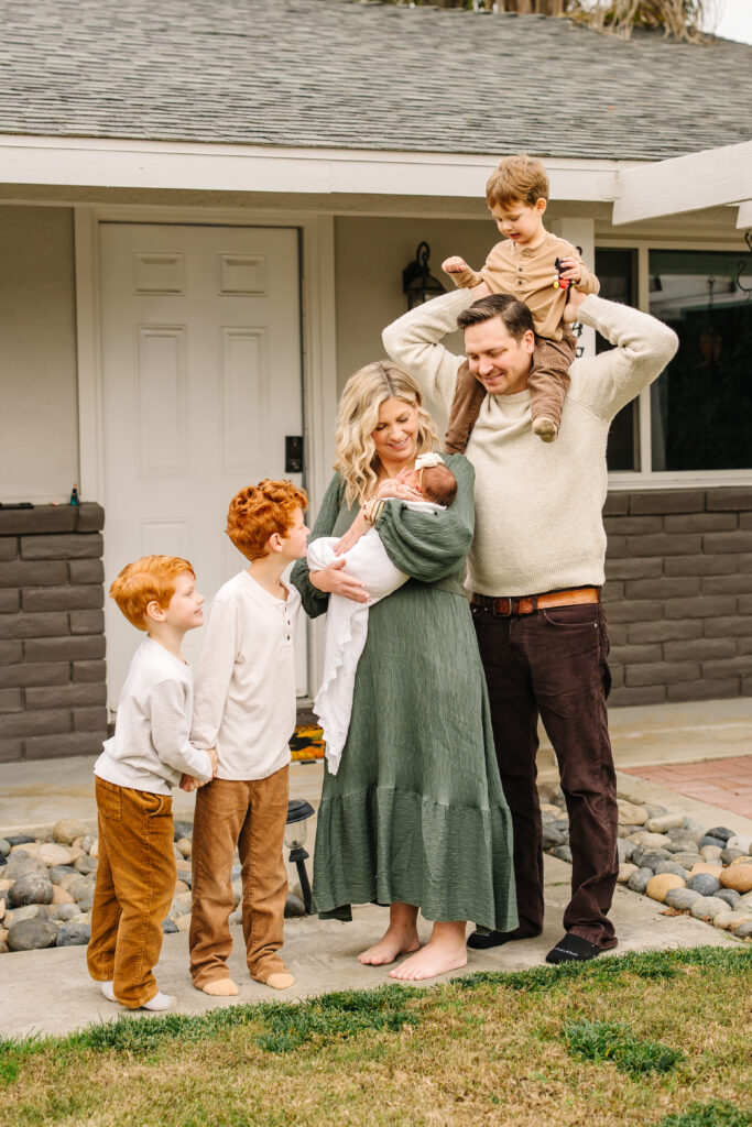 Parents exchanging loving glances with their four children during an in-home session.